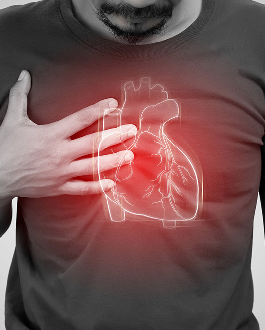Man holding chest needing a cardiologist in New City, NY